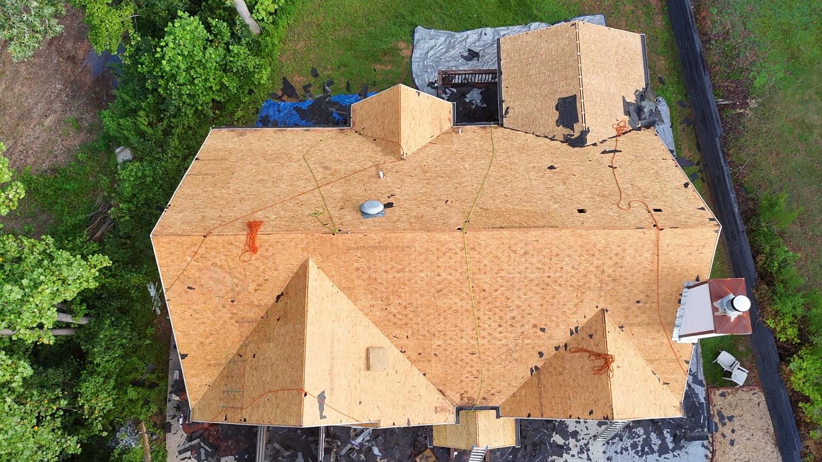 Aerial view of roof deck stripped down to OSB sheathing before re-roofing