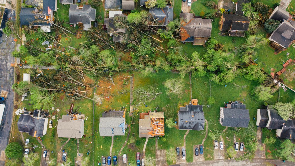 Aerial view of storm and wind damage in a residential neighborhood